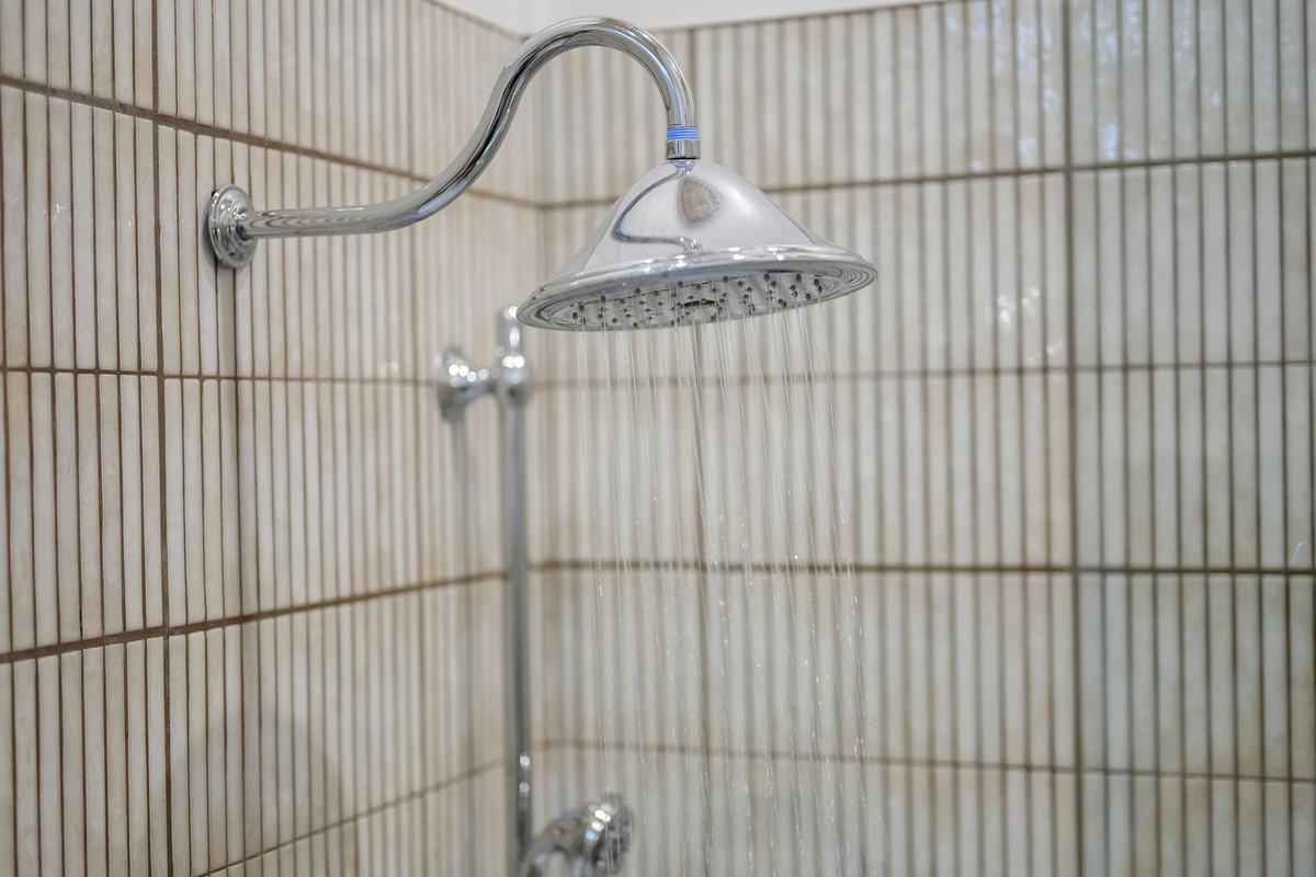 The primary ensuite bathroom offers a warm, spa-like experience with high-end finishes, luxurious touches, and a serene atmosphere designed for comfort and relaxation.