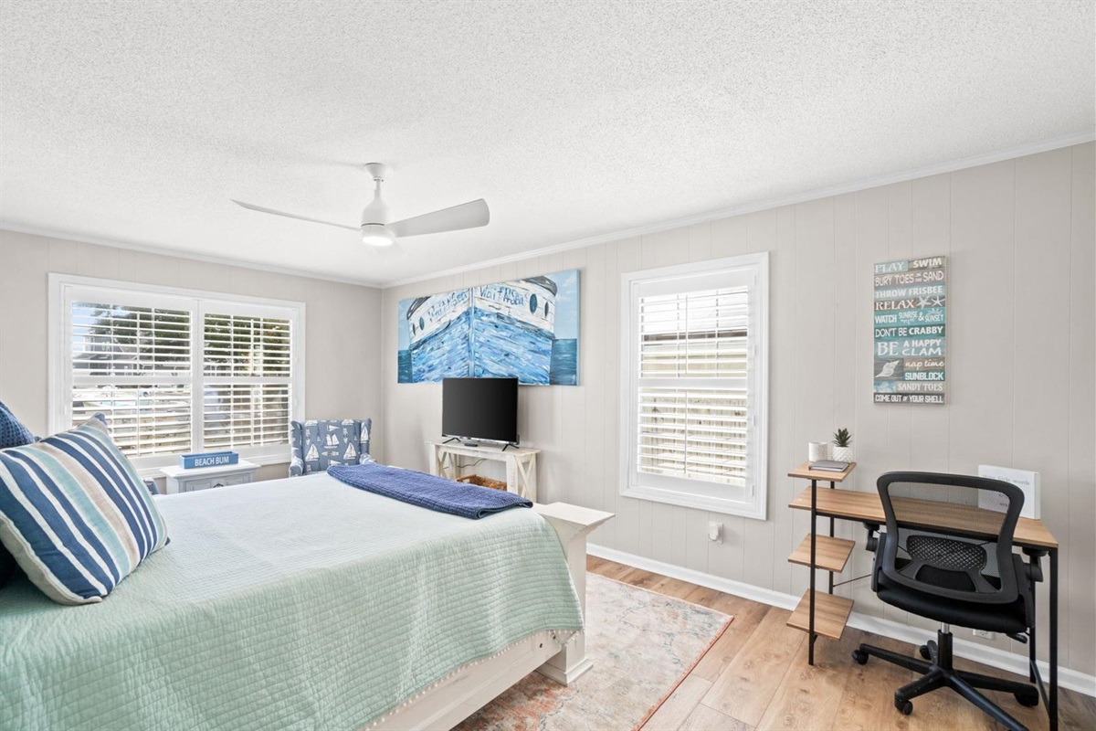 Second bedroom with queen bed, workspace and smart TV