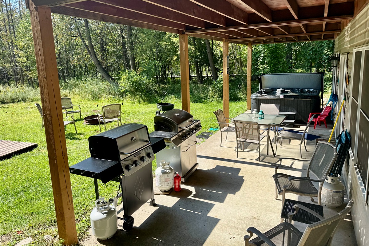 Lowerlevel patio includes propane grills, hot tub and lots of seating!