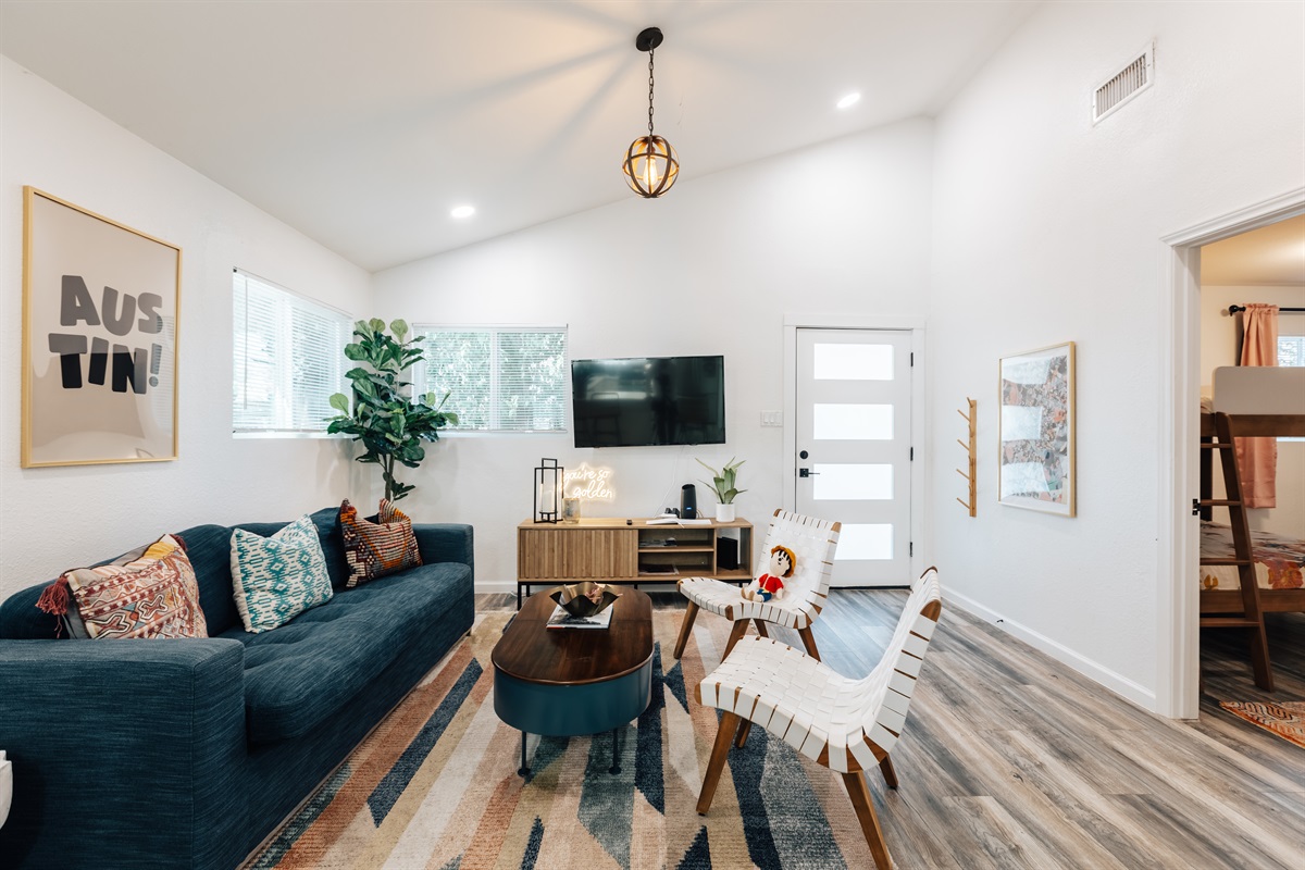 opening the door you enter the living room with one pull our queen size bed couch, chairs, big TV for group to relax and recharge,