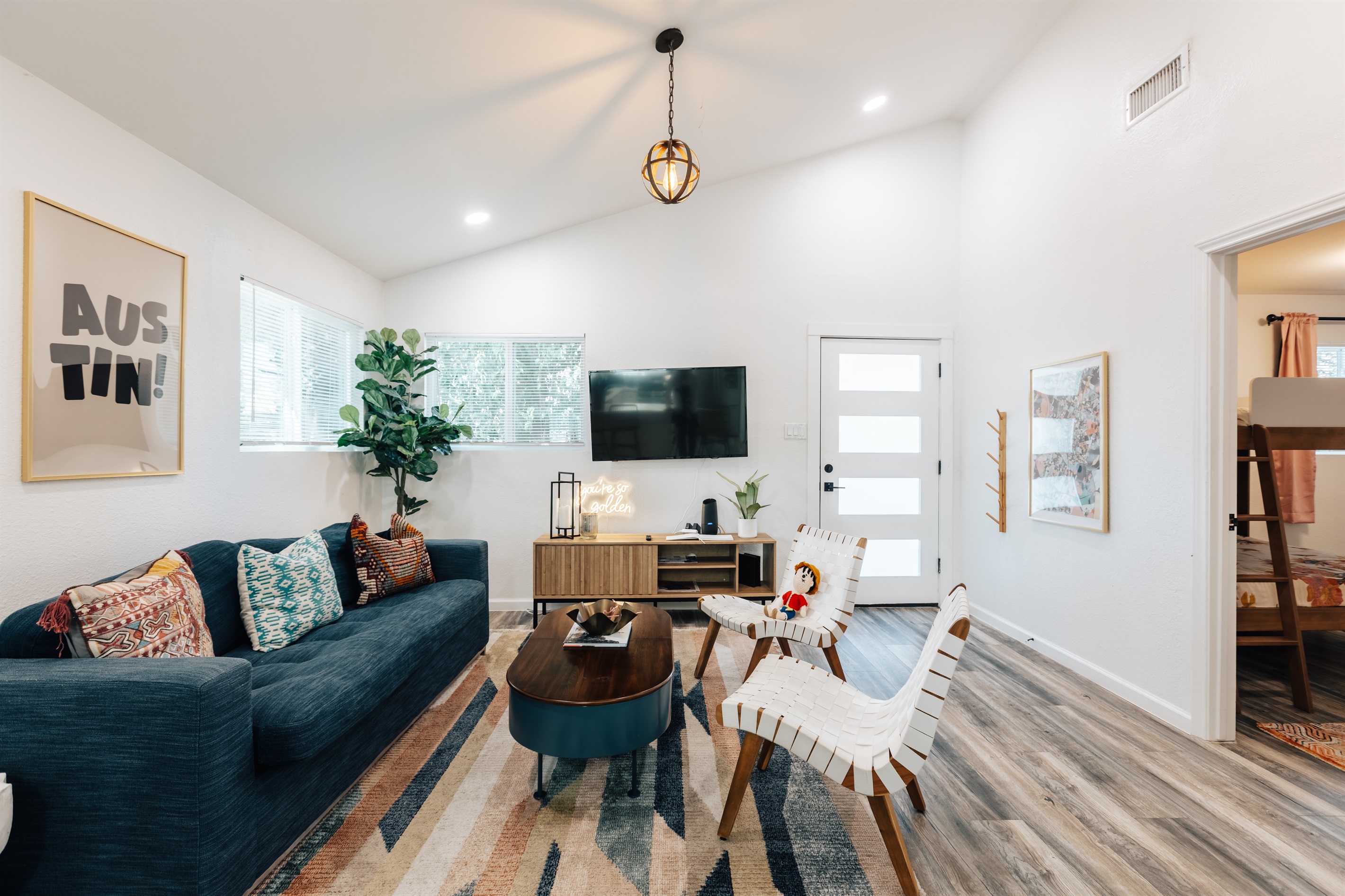 opening the door you enter the living room with one pull our queen size bed couch, chairs, big TV for group to relax and recharge,