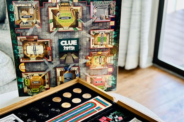 Combination board game set that includes Clue, Monopoly, checkers and Cribbage!