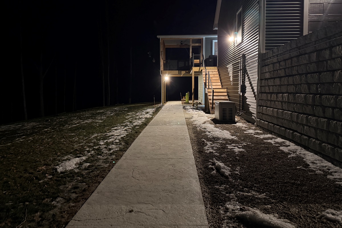 Path from driveway to front door motion-activated lights and flood light/cameras