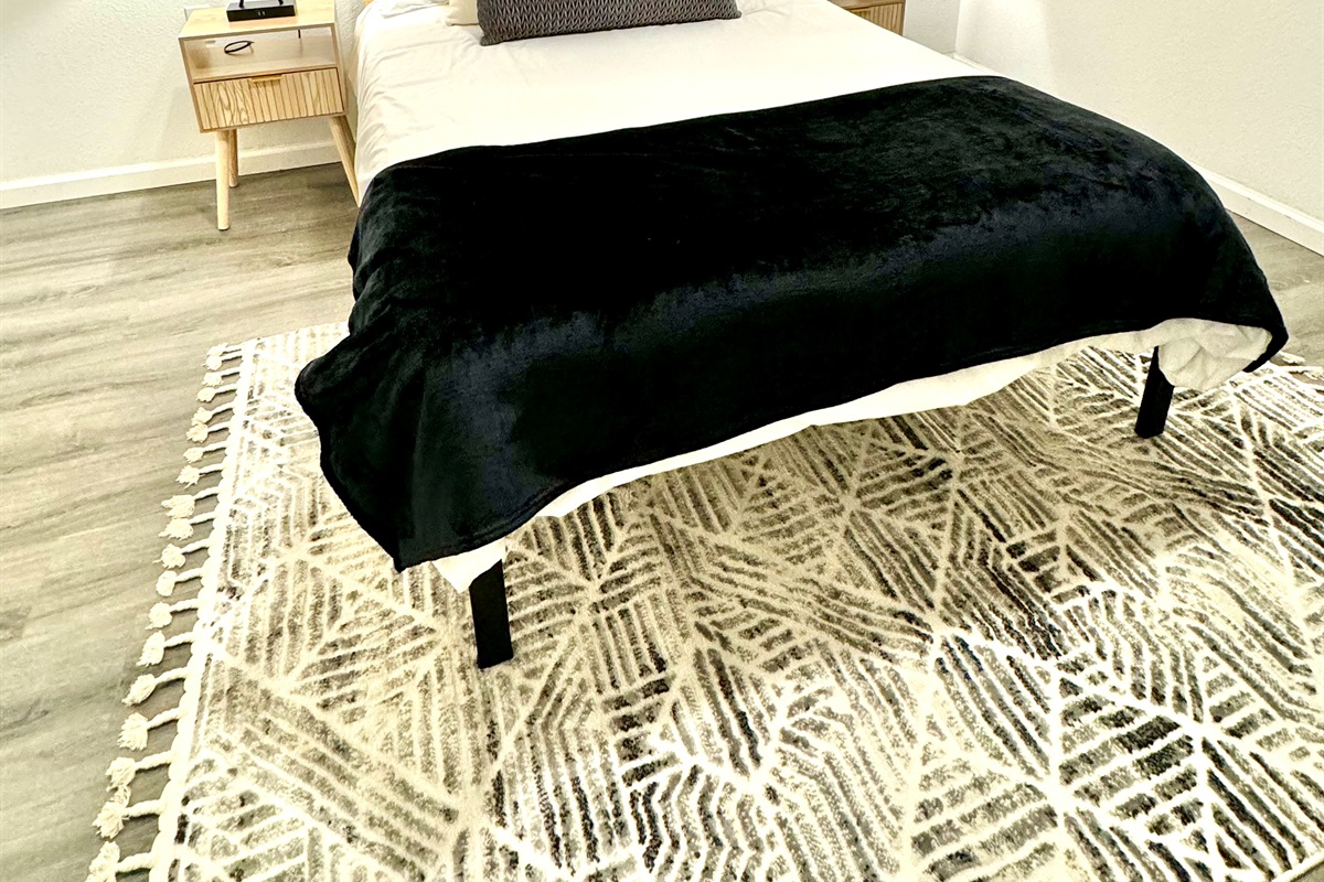 Basement bedroom with double bed and desk