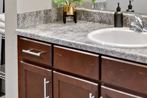 The primary bathroom has plenty of storage in the vanity; use the drawers or cabinets.