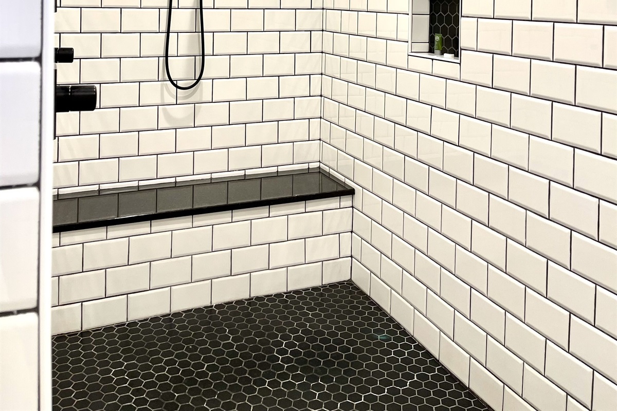 A 10 foot fully tiles shower with granite bench. The shower features FOUR shower heads!