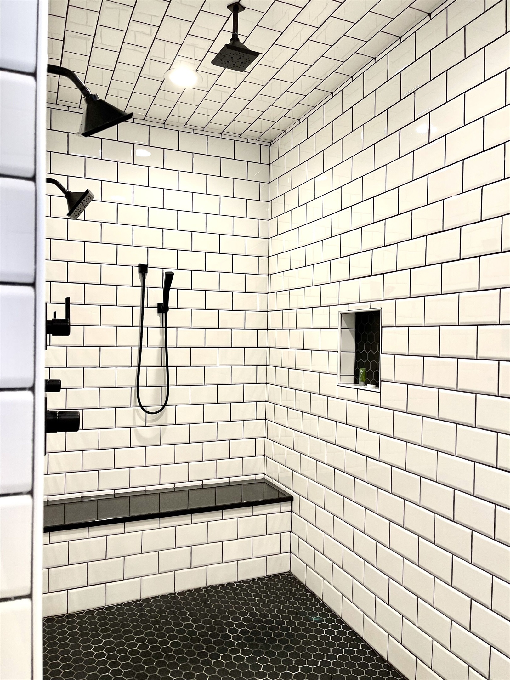 A 10 foot fully tiles shower with granite bench. The shower features FOUR shower heads!