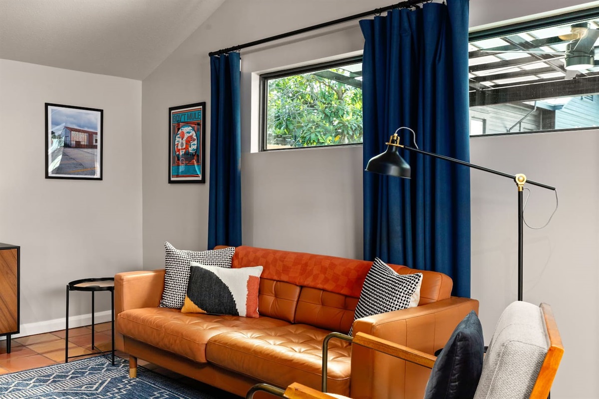 Living area: Love seat, couch, and 50 inch Smart TV with DVD player