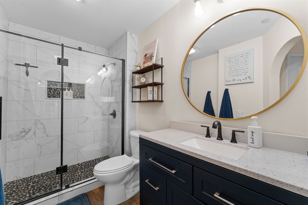 Modern bath with glass walk-in shower.