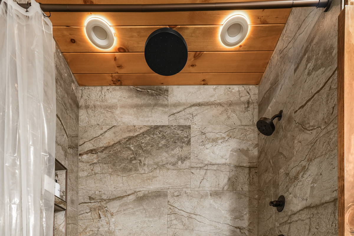 Main Floor Master King Suite –Enjoy the luxurious spa-style shower with a rain, hand & full shower head for the perfect start or end to your day. Plush towels & premium sulfate / paraben free shampoo, conditioner & body wash are provided.