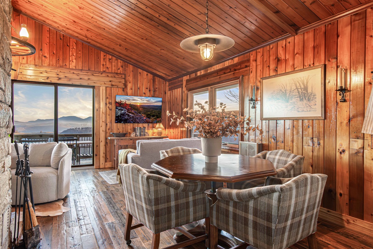 A cozy dining nook with mountain views—perfect for family meals, game nights, or slow mornings with coffee, surrounded by the charm of the original cabin.