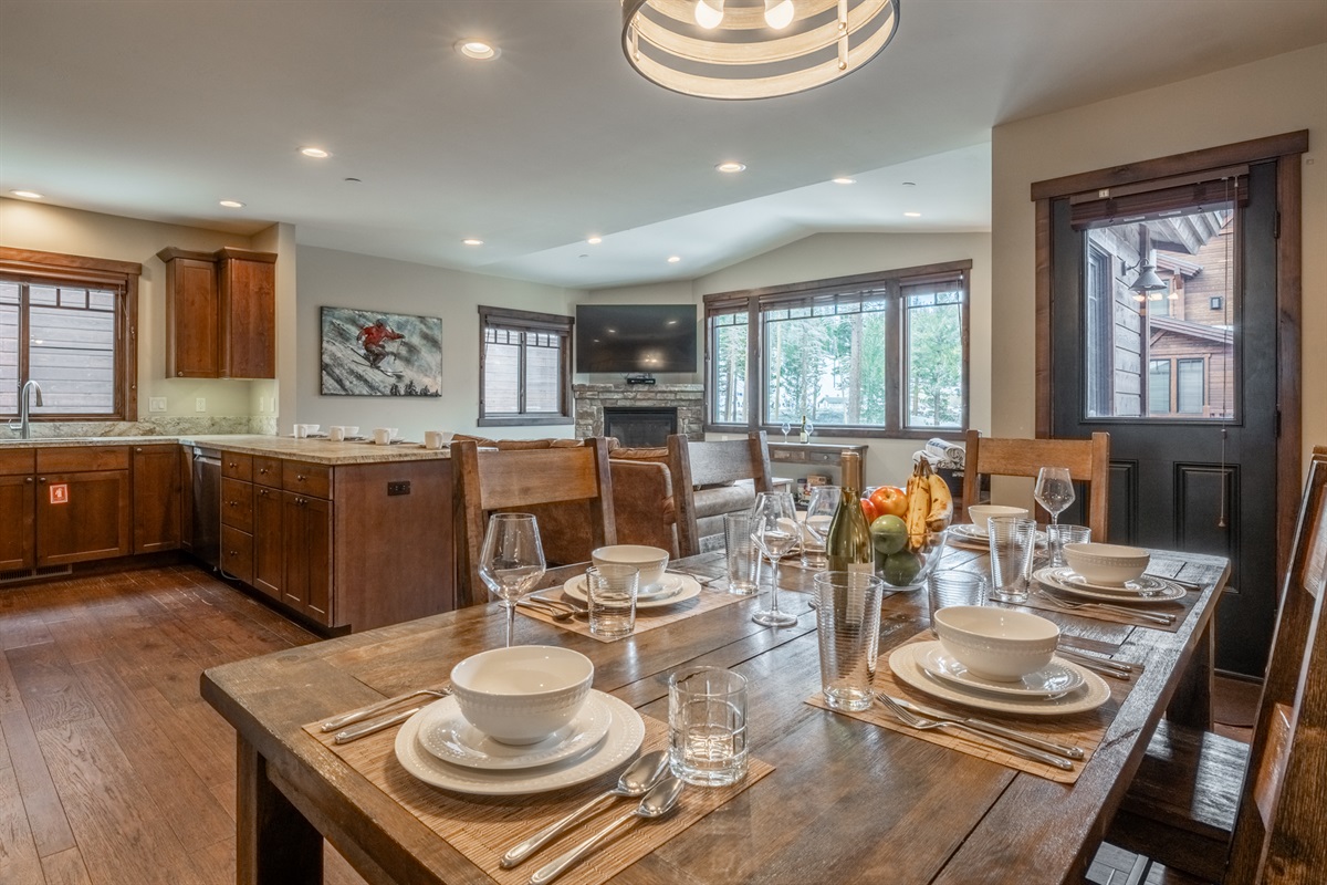 Dine together with mountain light streaming in, surrounded by a seamless flow from kitchen to living space.