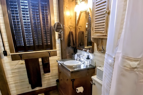 Main level bathroom features repurposed cabinet for vanity 