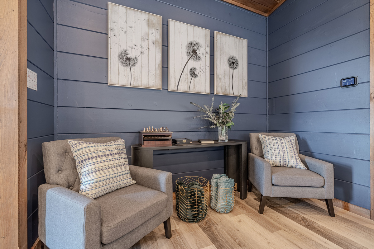 A quiet game or reading nook with comfortable chairs and a chess set.