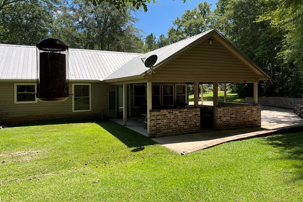 Back patio opens up large backyard 
Great for sitting in the shade while the kids or pets play in the cleared 1 Acre yard