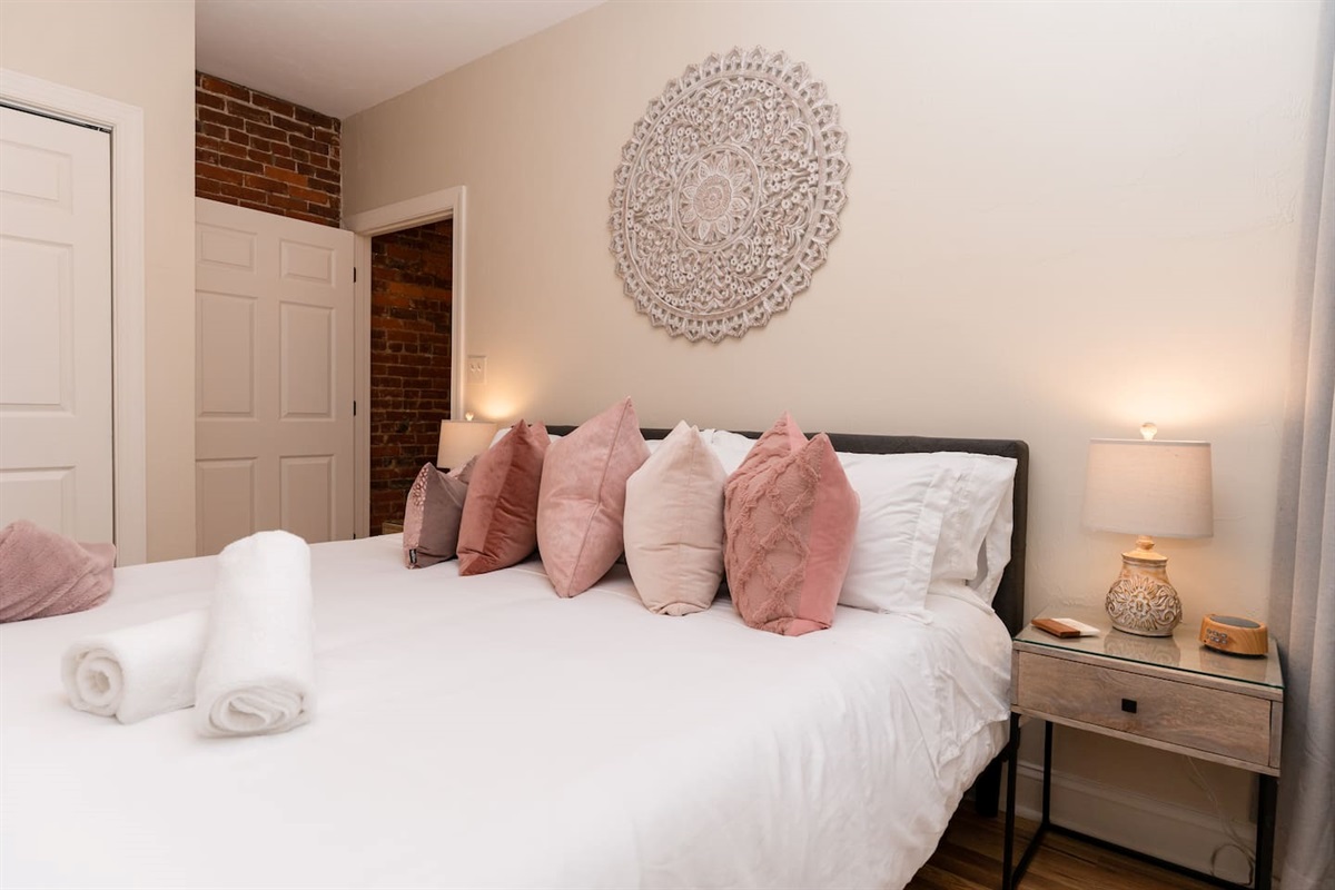 King-sized bedroom with a side window, offering plenty of natural light and comfort.