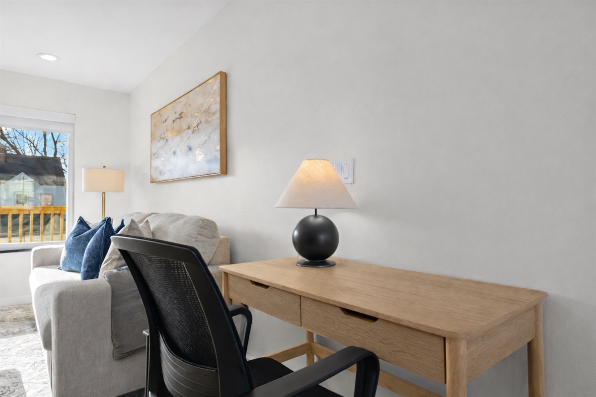 Dedicated workspace with a comfortable desk and chair, natural light, and a quiet setting—perfect for remote work or focused productivity.