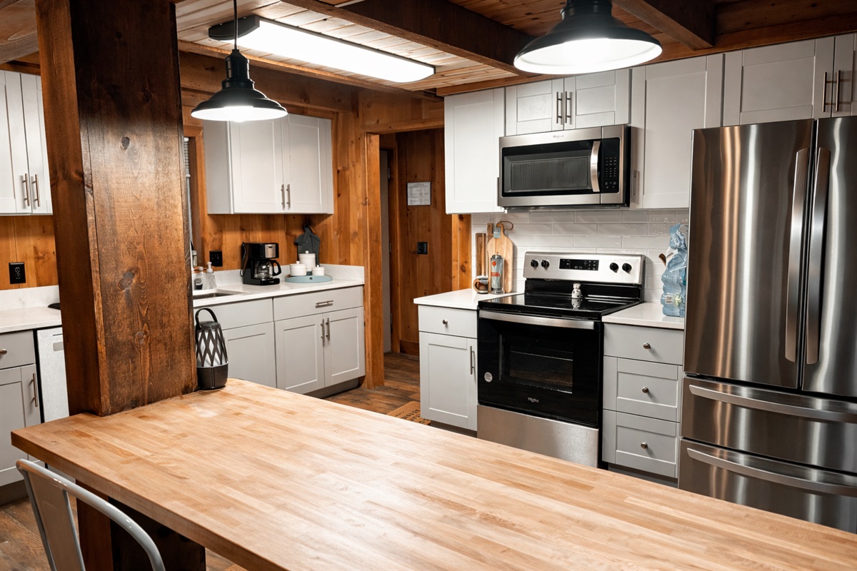A fully stocked kitchen with stainless steel appliances and a spacious island—perfect for cooking breakfast before a day exploring the North Georgia mountains.