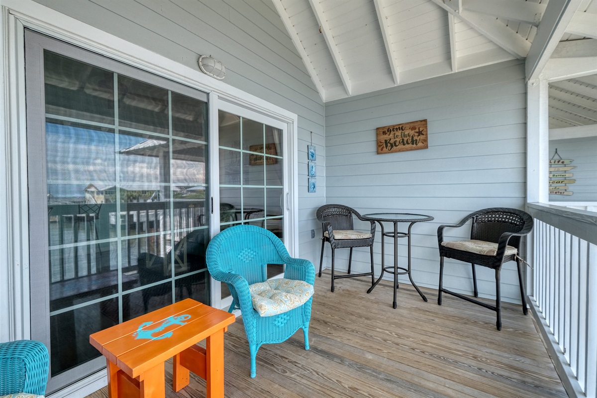 Bistro table and chairs on porch for outdoor dining