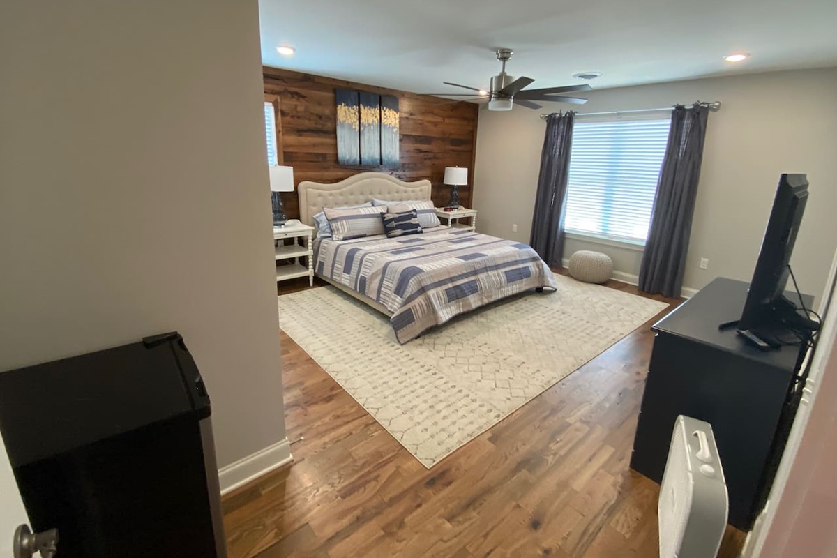 Kind bedroom on second level with ensuite bath and small refrigerator.