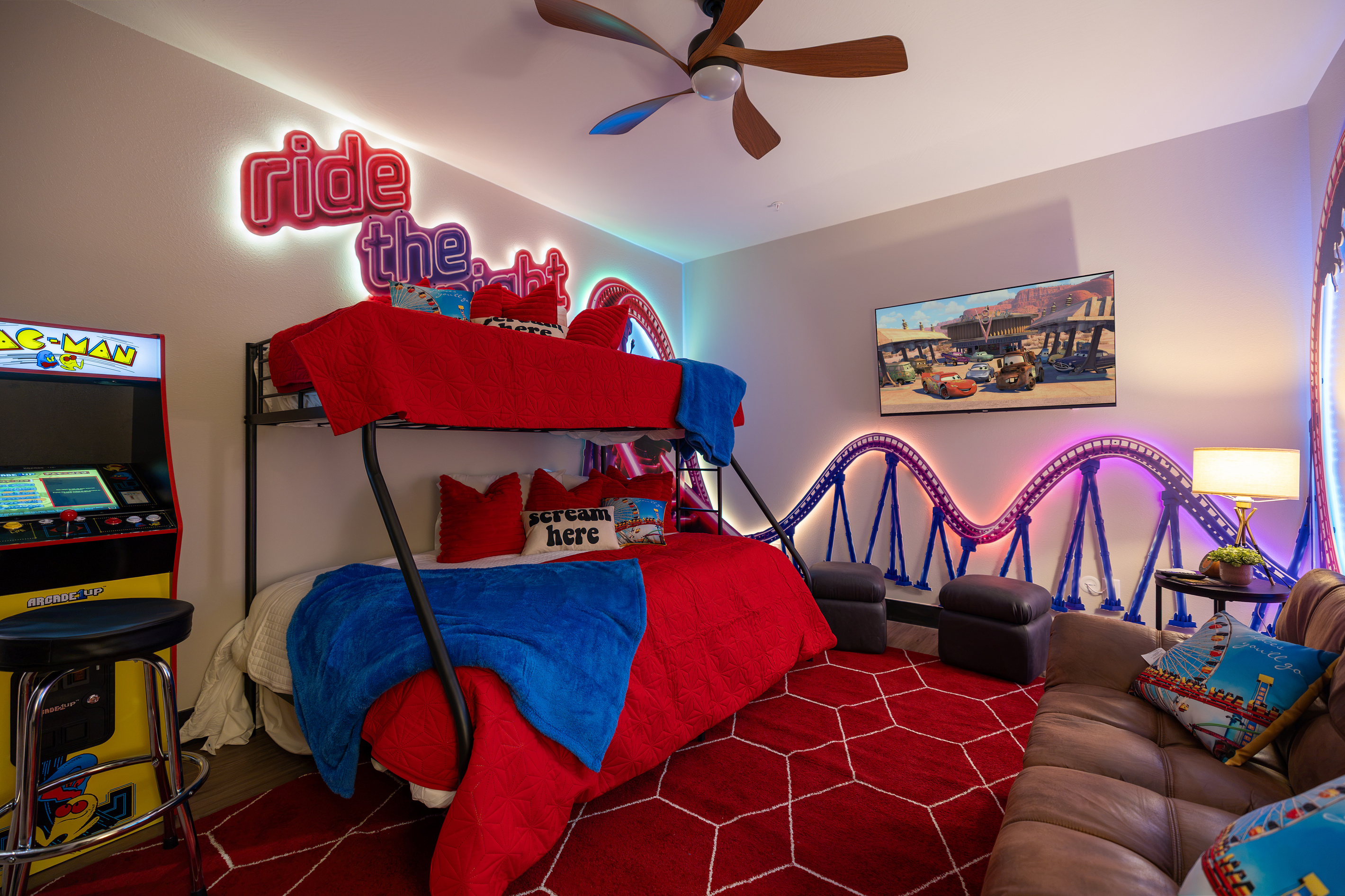 Bunks on one side, arcade on the other, mural all around.