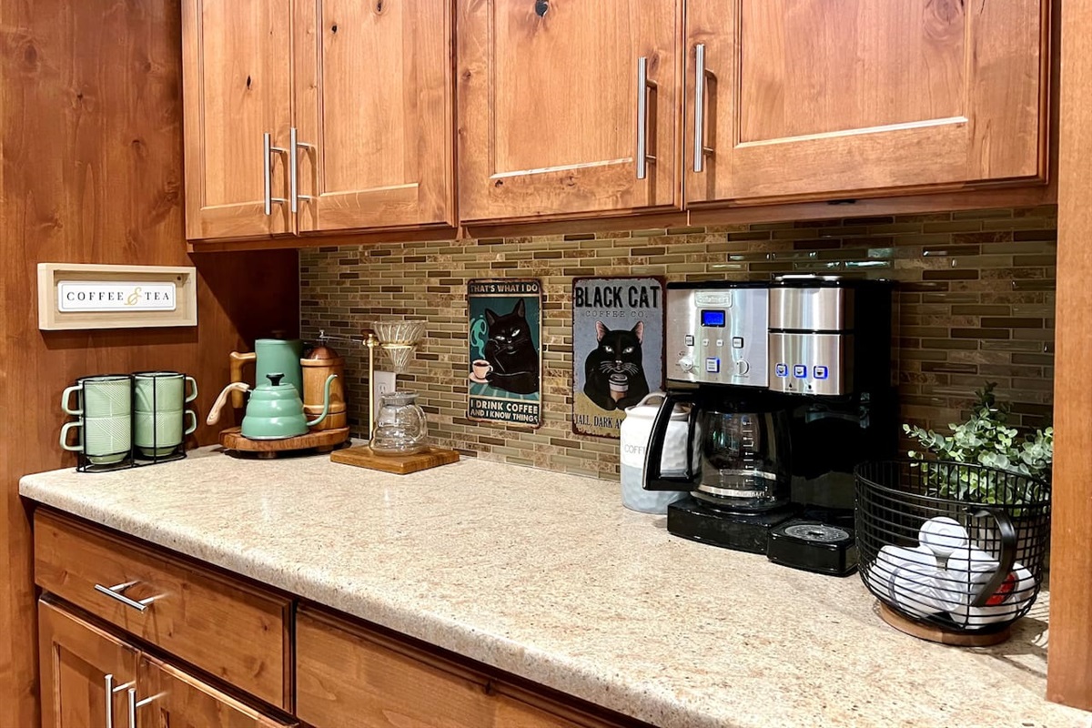Kitchen coffee area includes drip coffee maker, K-cup maker, French press, and poor over coffee stand