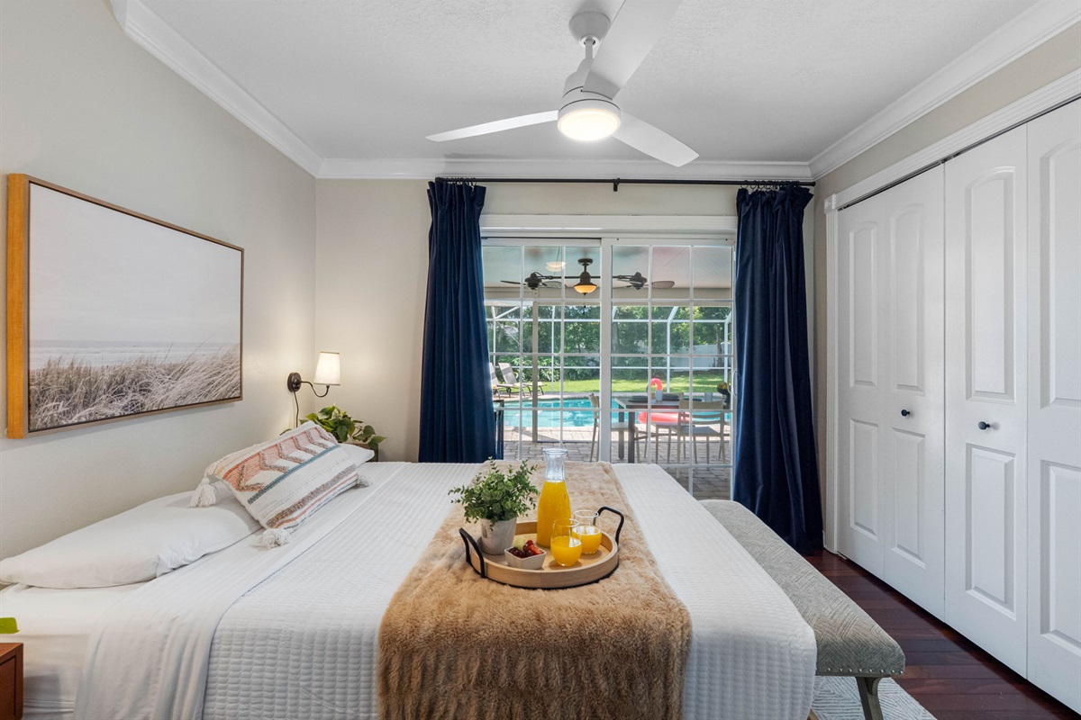 Serene bedroom retreat with sliding glass doors opening directly to the poolside patio.