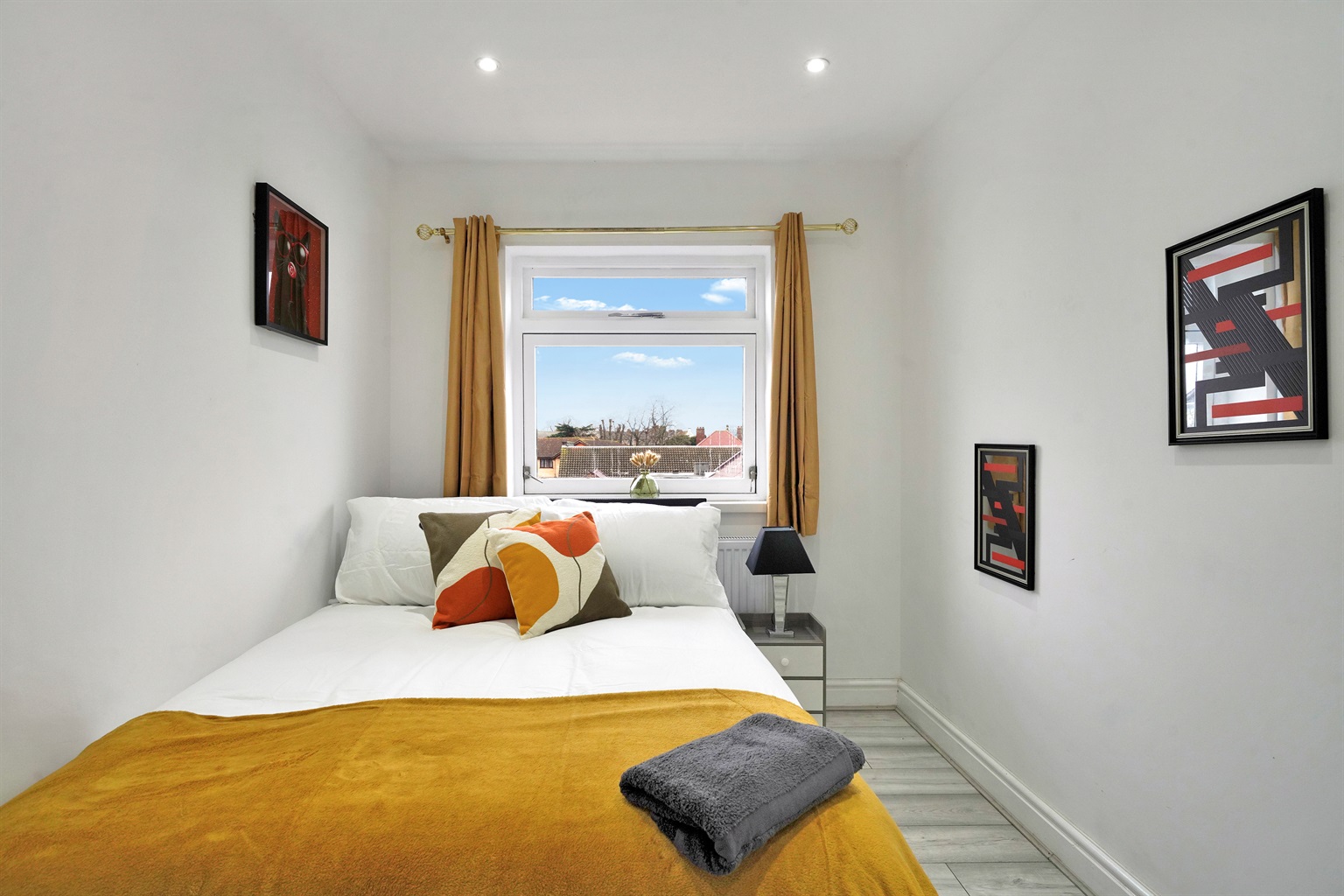 [cosy double bed, bedside lamp, calming decor]