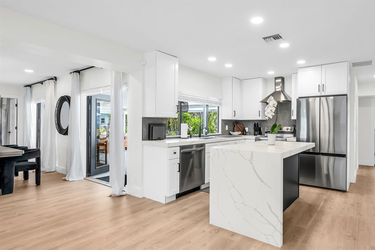Bright and airy, this modern kitchen combines luxury finishes with everyday comfort. Enjoy the designer backsplash, expansive counter space, and seamless flow to the dining and living areas.