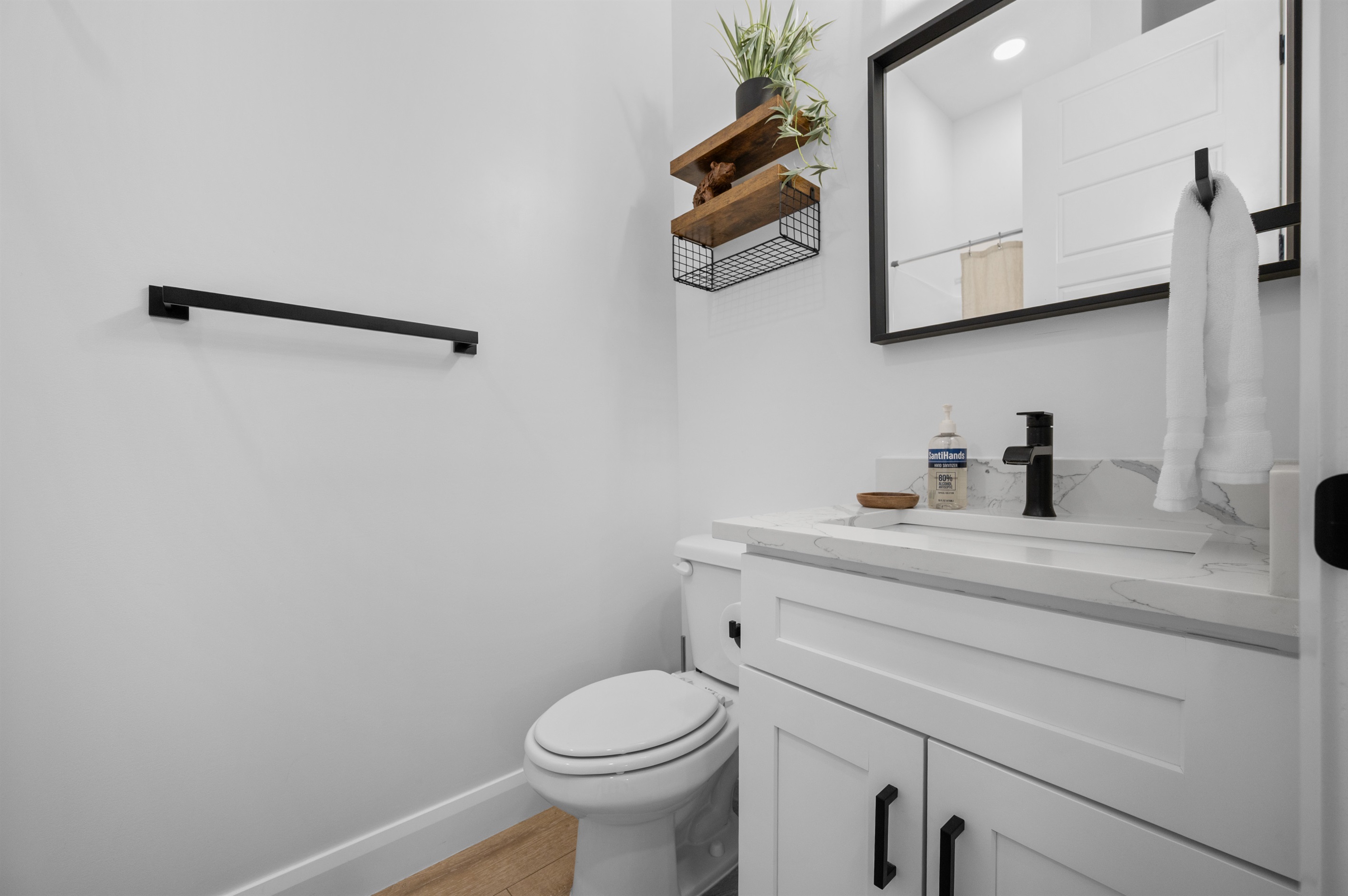 Upstairs full bath with bright lighting and sleek design.