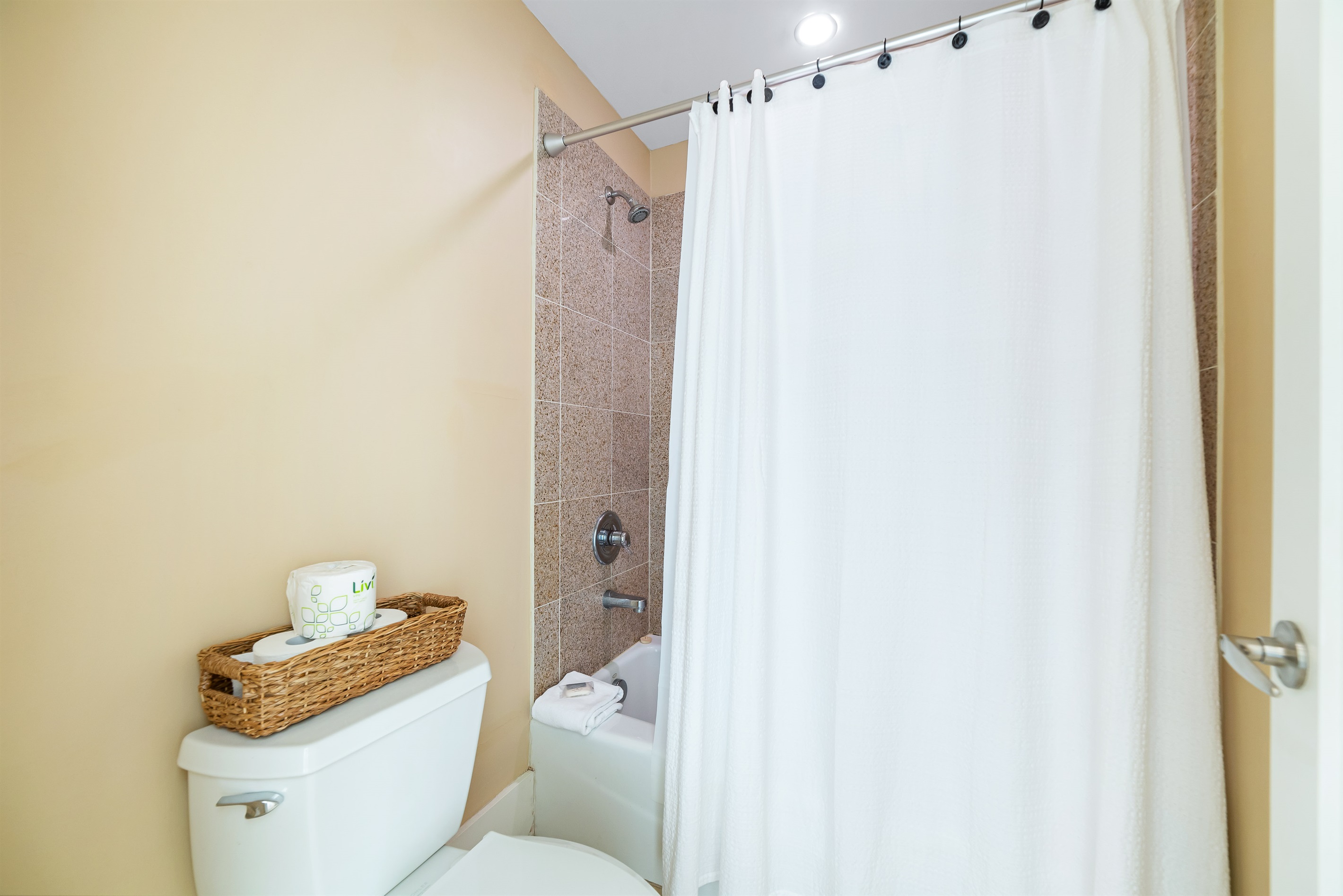 Freshly updated bathroom featuring a shower/tub combination, ample vanity space, and modern fixtures.