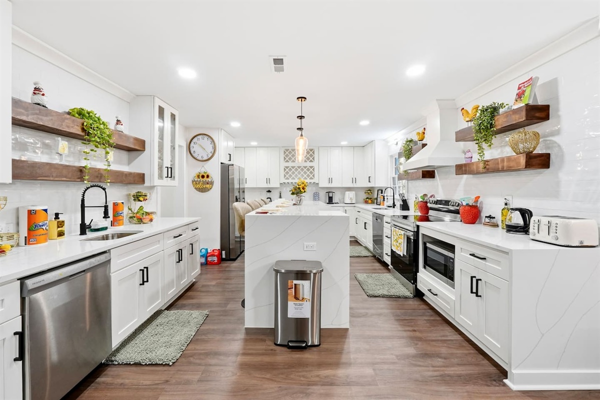 Beautiful white kitchen fully equipped with all the appliances and essentials of a home away from home.