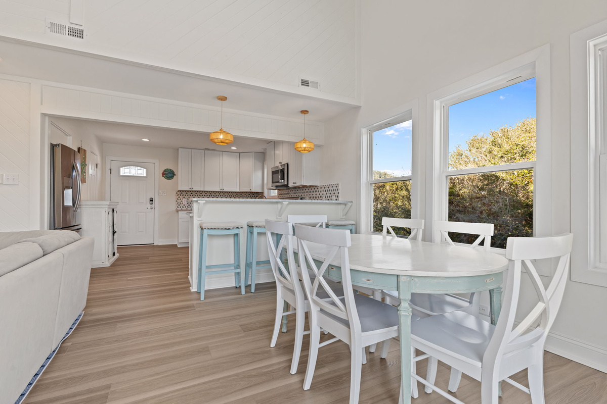 Share meals and stories around the dining table, with beautiful natural light and easy access to the outdoor deck