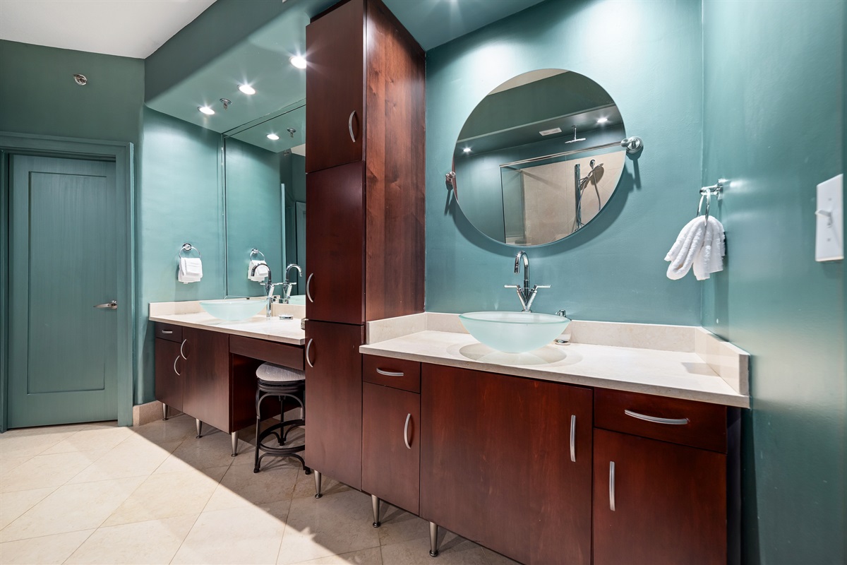 A thoughtfully designed wet bar seamlessly integrates into the living space, featuring elegant countertops and a chic vessel sink.