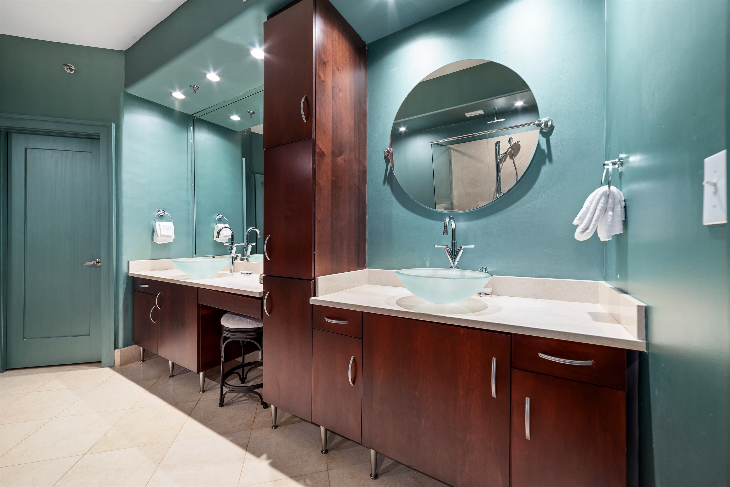 A thoughtfully designed wet bar seamlessly integrates into the living space, featuring elegant countertops and a chic vessel sink.