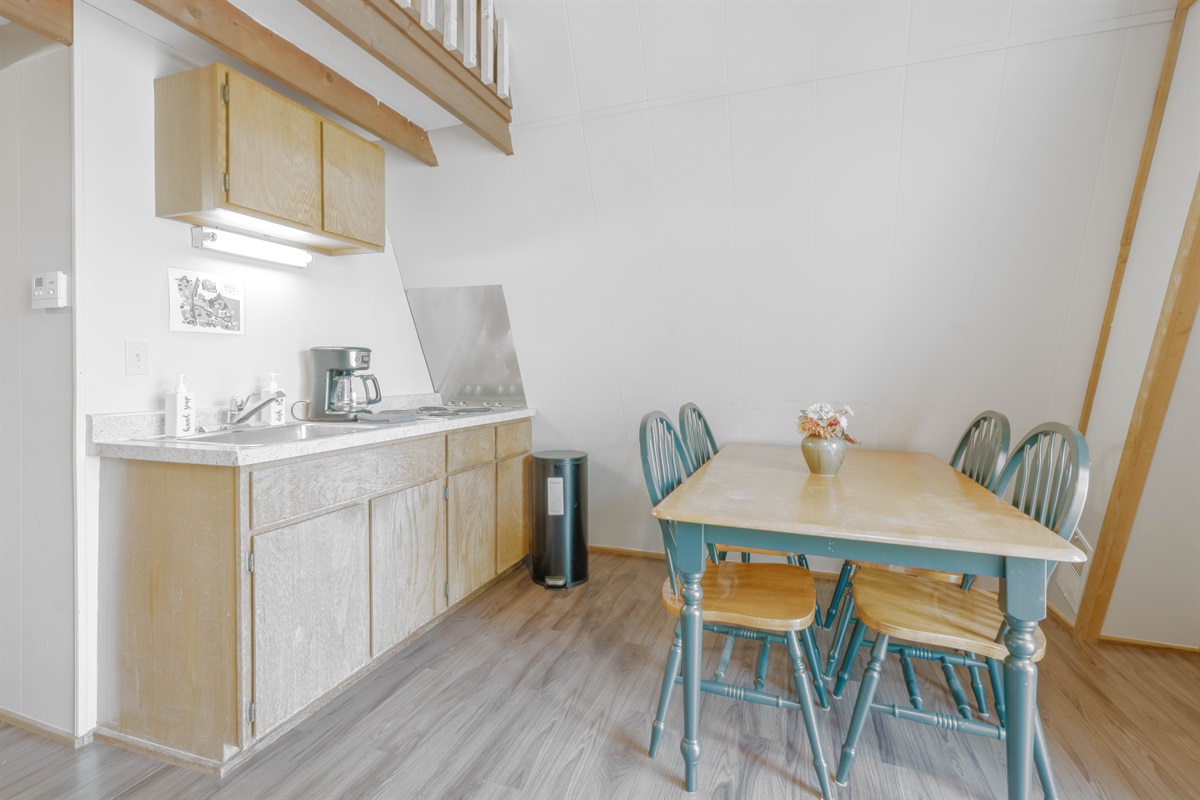 Kitchenette with stove top, microwave, and fridge