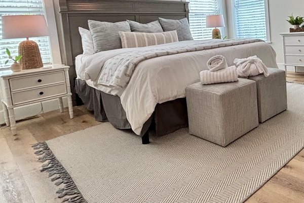 Welcome to your serene getaway! This beautifully designed bedroom features a cozy fireplace and 50" LED TV, vaulted ceilings, stylish decor, and a touch of modern elegance. Perfect for relaxation after a day of adventures. Your tranquil escape awaits!