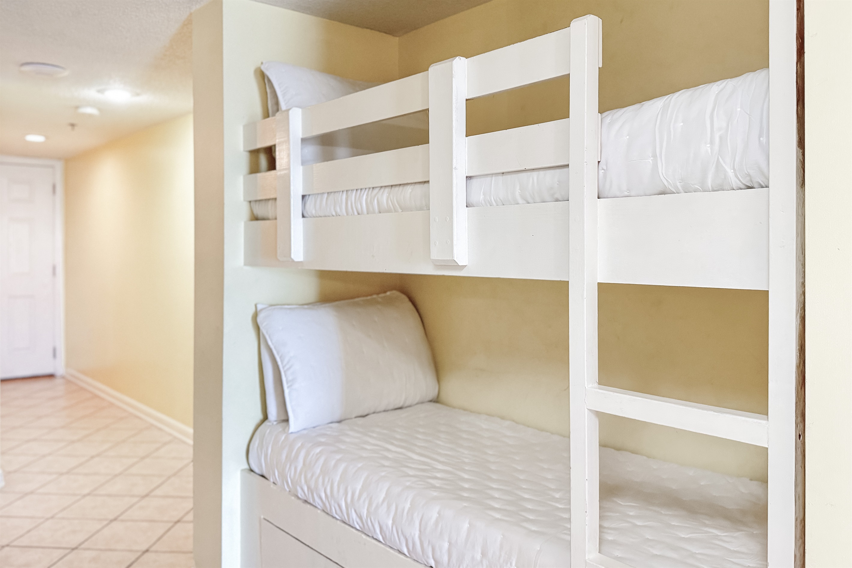 Tucked away for privacy, this charming hallway bunk offers a fun and comfortable spot for the kids (or extra guests!) to rest after a day of adventure.