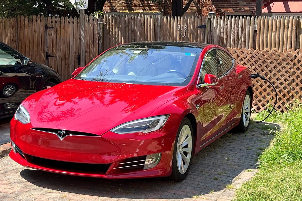 Guest using complimentary EV ChargePoint station and parking for Tesla Model S.Rear Parking Space, Back of House (21’ long x 10’ wide).