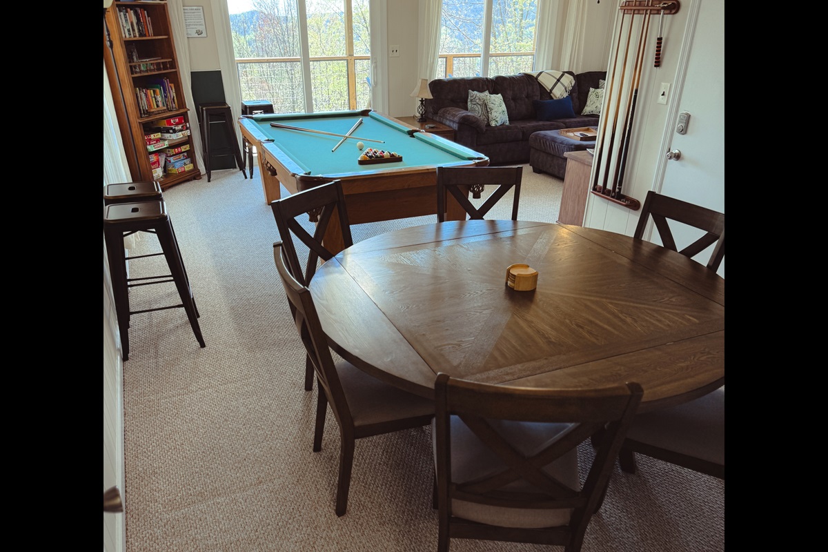 Game Room Fun with amazing views! We have a large sectional sofa with sofa bed, 55" Roku smart TV, gas fireplace, pool table with ping pong inserts, game table, books, games, puzzles, etc.