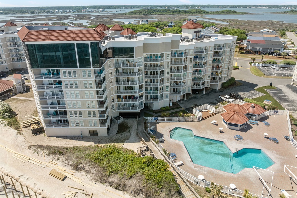 Resort-style pool deck with oceanfront views and private beach access
