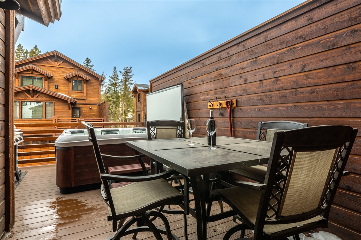Double Black (MS2) private balcony features a hot tub with views of Canyon's runs, outdoor seating, and a BBQ grill (seasonally available) — your own alpine perch for soaking, grilling, and unwinding after a day at Canyon.