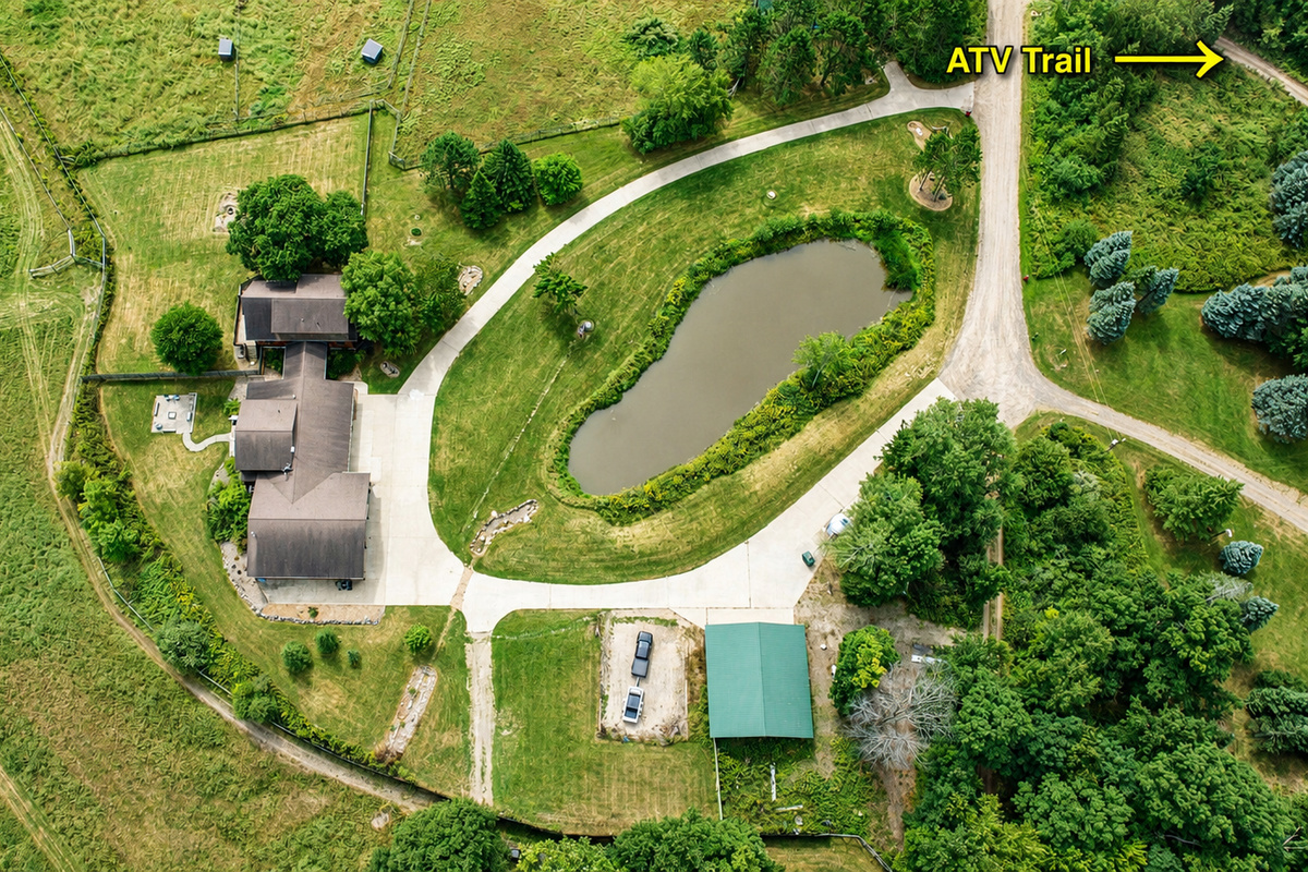Aerial view of the property with plenty of parking for trucks and trailers and the ATV trail just steps away. Bring your machines, unload with ease, and ride straight from the property for an unforgettable Northwoods adventure.