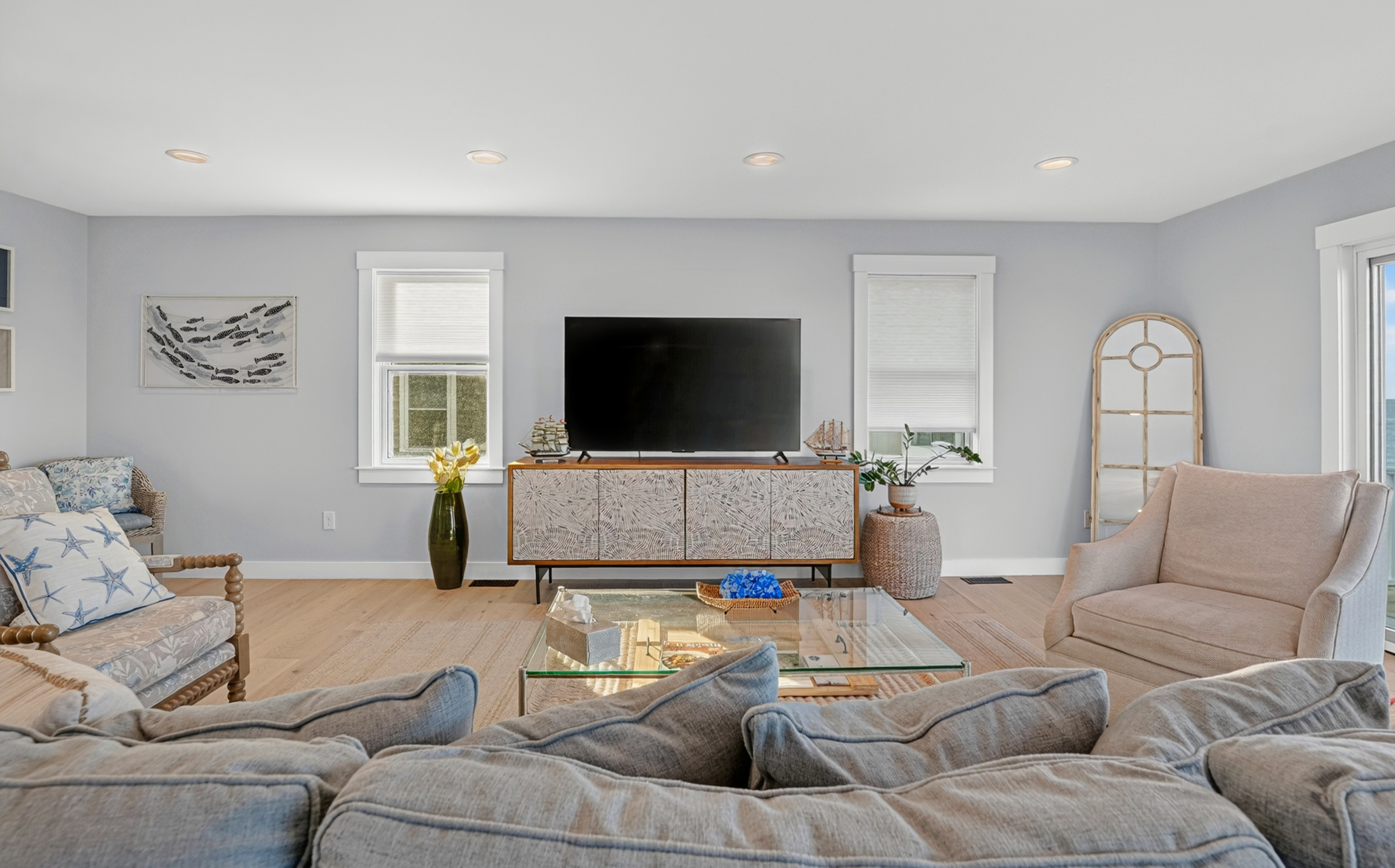 Inviting living room featuring plush seating and a large smart TV for entertainment