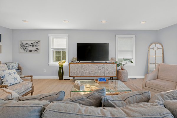 Inviting living room featuring plush seating and a large smart TV for entertainment