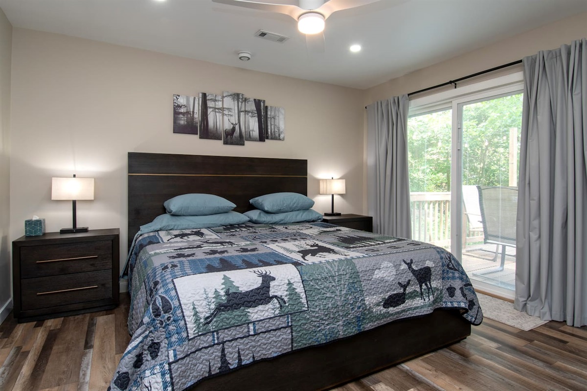 King sized bed and ample storage space for clothing.  Ceiling fan, dimmable lights and room darkening curtains. Patio door leads to deck with hot tub. 