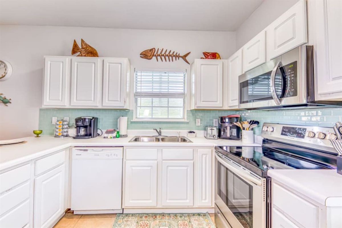 Kitchen: Bright and inviting space with modern appliances and fish-themed decor!