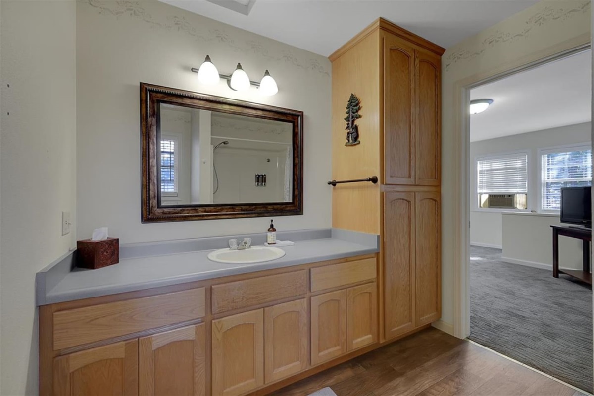 Full Bathroom 3 with vanity storage, a large mirror, and easy access from the nearby common area.
