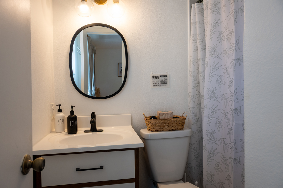 Vanity, oval mirror and hotel-style toiletries