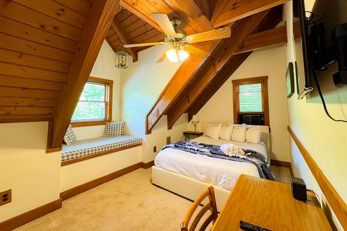 The upper level bedroom has a queen size bed and its own TV